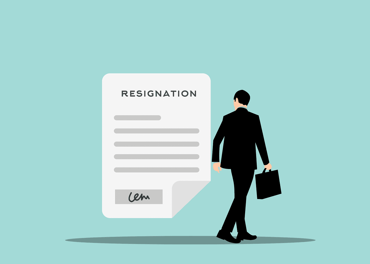 The image depicts a man in a business suit walking away from a large resignation letter displayed in the foreground. The resignation letter is labeled clearly at the top and contains several lines of text, symbolizing the formal process of resignation. The man, carrying a briefcase, represents a professional moving on from his current position, possibly towards new opportunities.